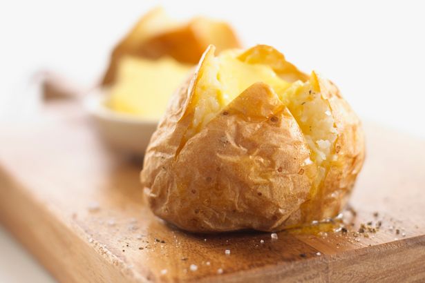 A jacket potato with butter salt and pepper on a wooden chopping board Everything you know about diets is wrong   and you CAN eat food you think